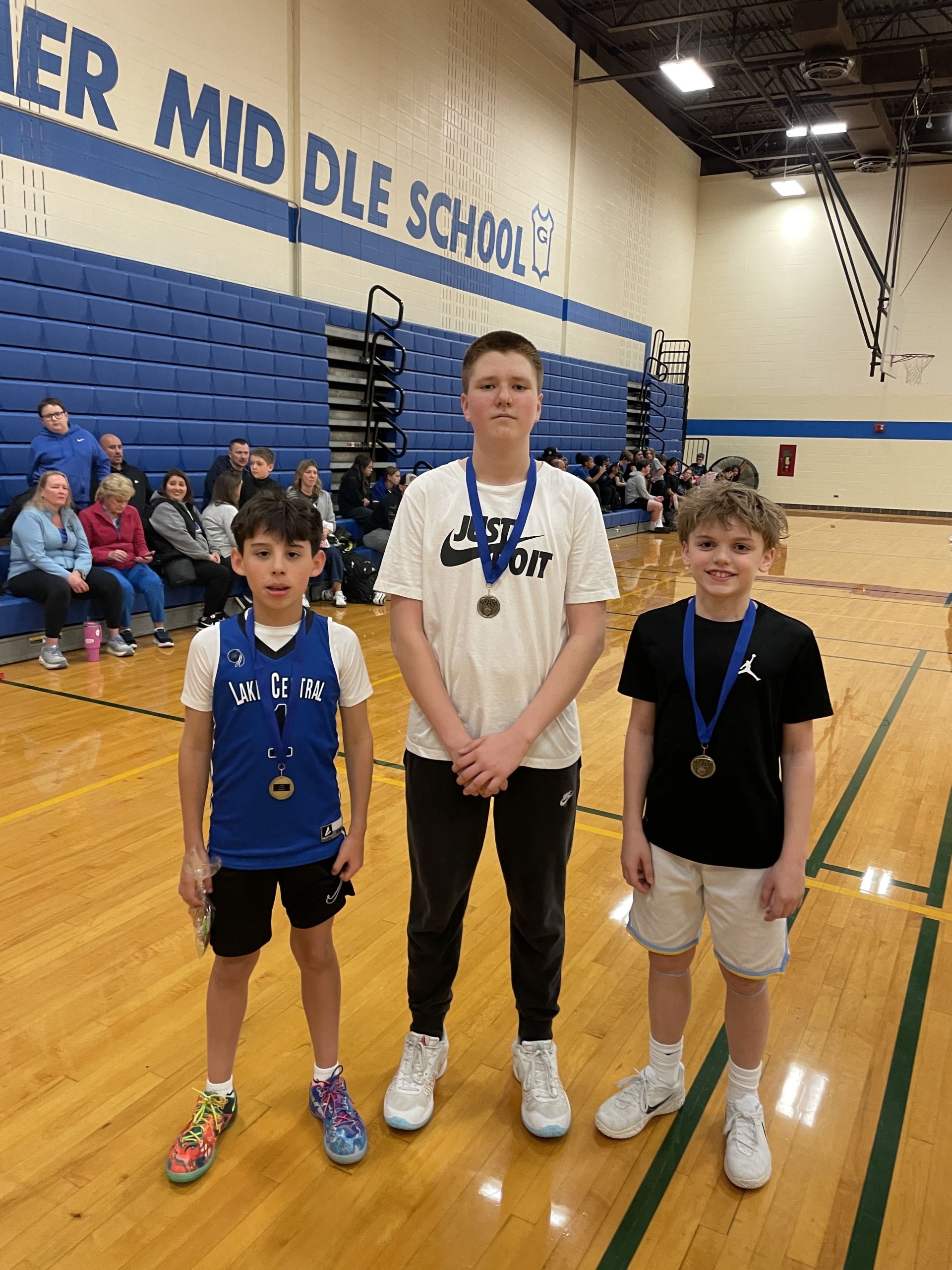 Grimmer boys wearing medals and posing in the gym.