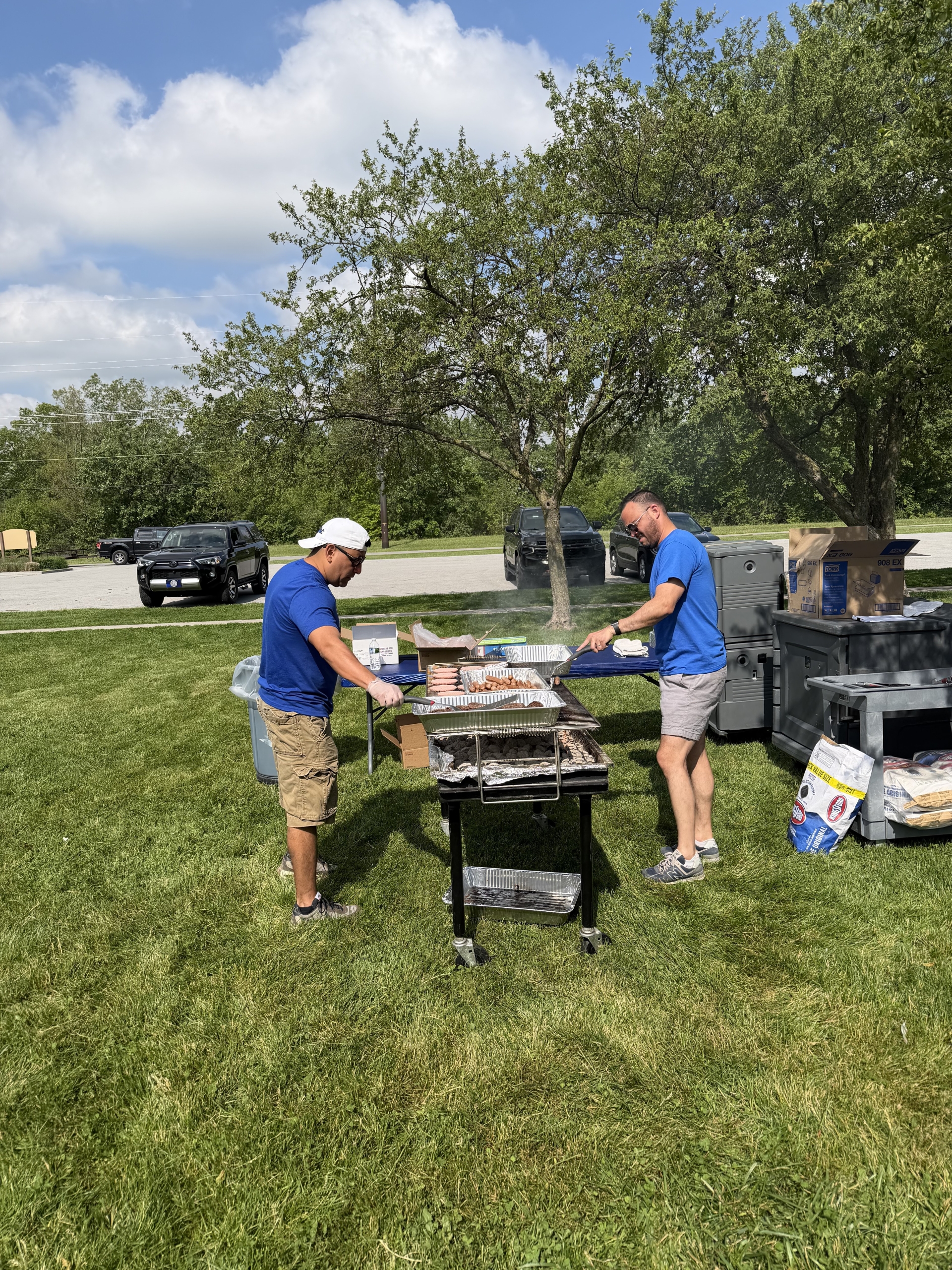 Mr. Bounds and Mr. Castaneda grilling for Grimmer end of year picnic.
